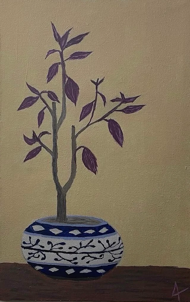 A purple-leaved plant in a blue-and-white patterned pot against ochre.